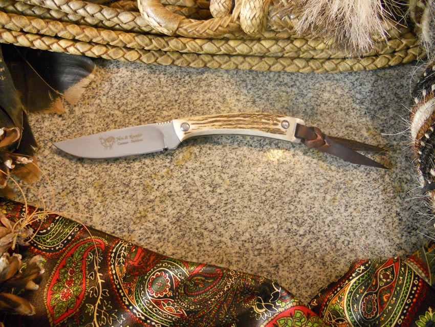benchmark knives with an eagle symbol on blade